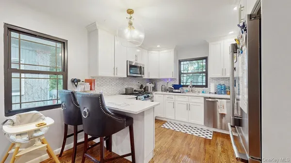 a kitchen with a dining table chairs and refrigerator
