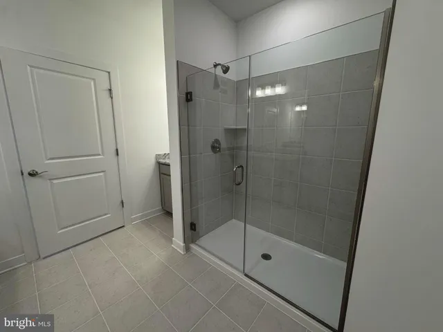 a bathroom with a shower and a glass door