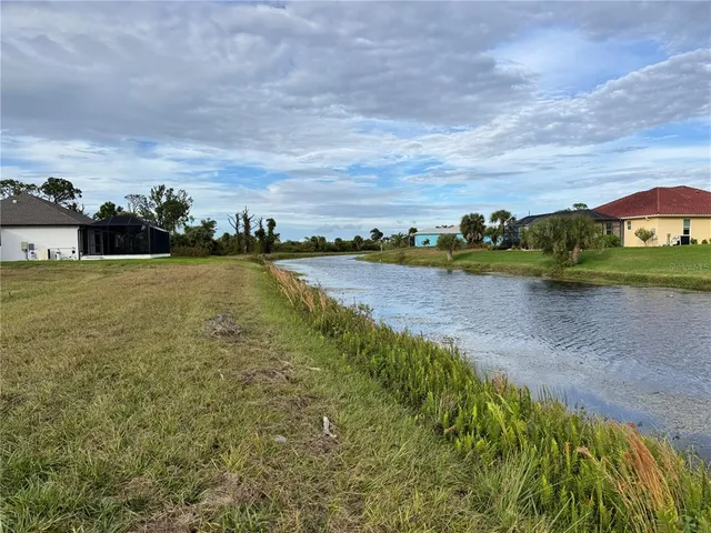 a view of a lake with houses in the back