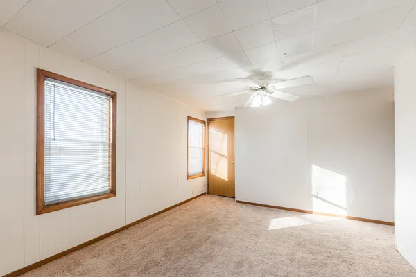an empty room with windows and closet