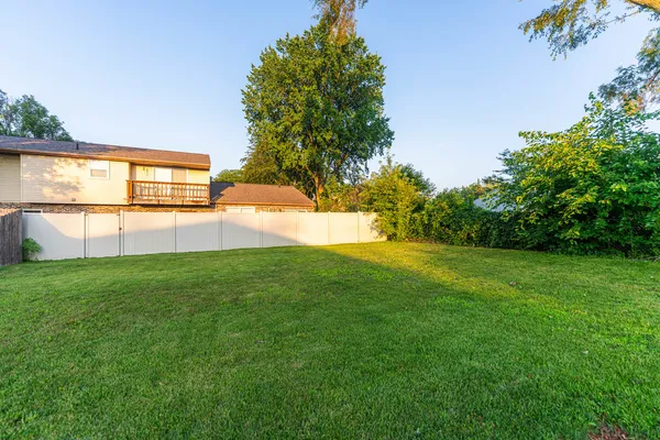 a sign board with yard in front of it