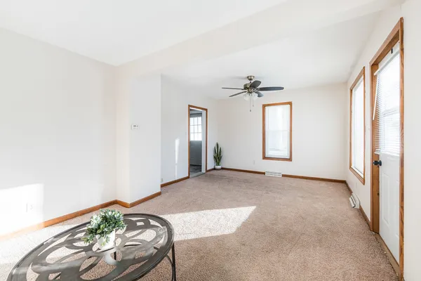 an empty room with windows and wooden floor