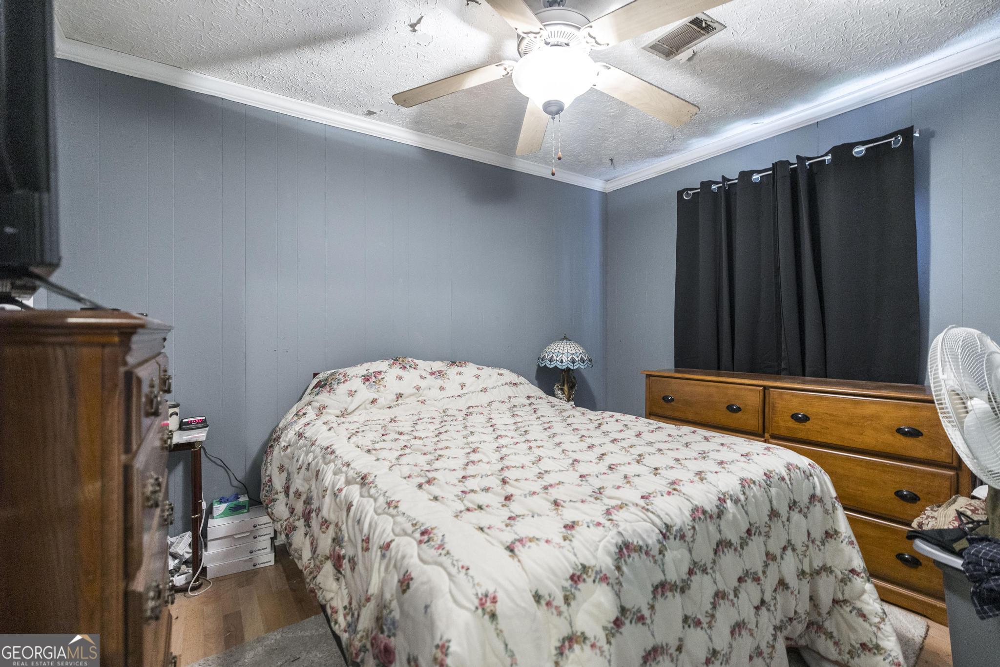 249 Ward Street Warner Robins, GA 31093 - Photo 17 of 22 a bedroom with a bed and a chandelier