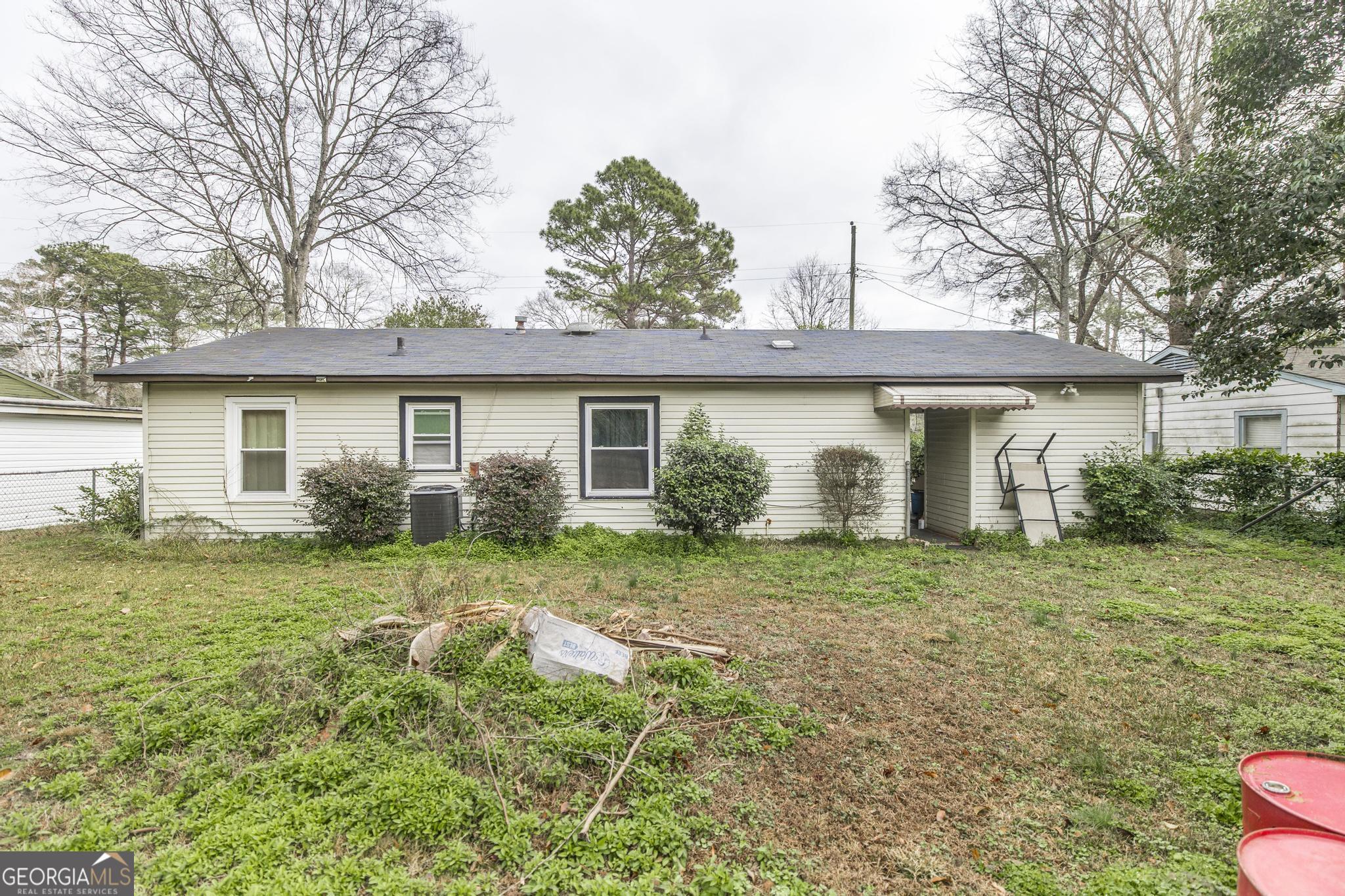 249 Ward Street Warner Robins, GA 31093 - Photo 20 of 22 a view of a house with a yard and potted plants