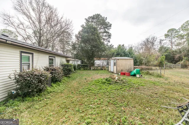 a backyard of a house with plants and trees