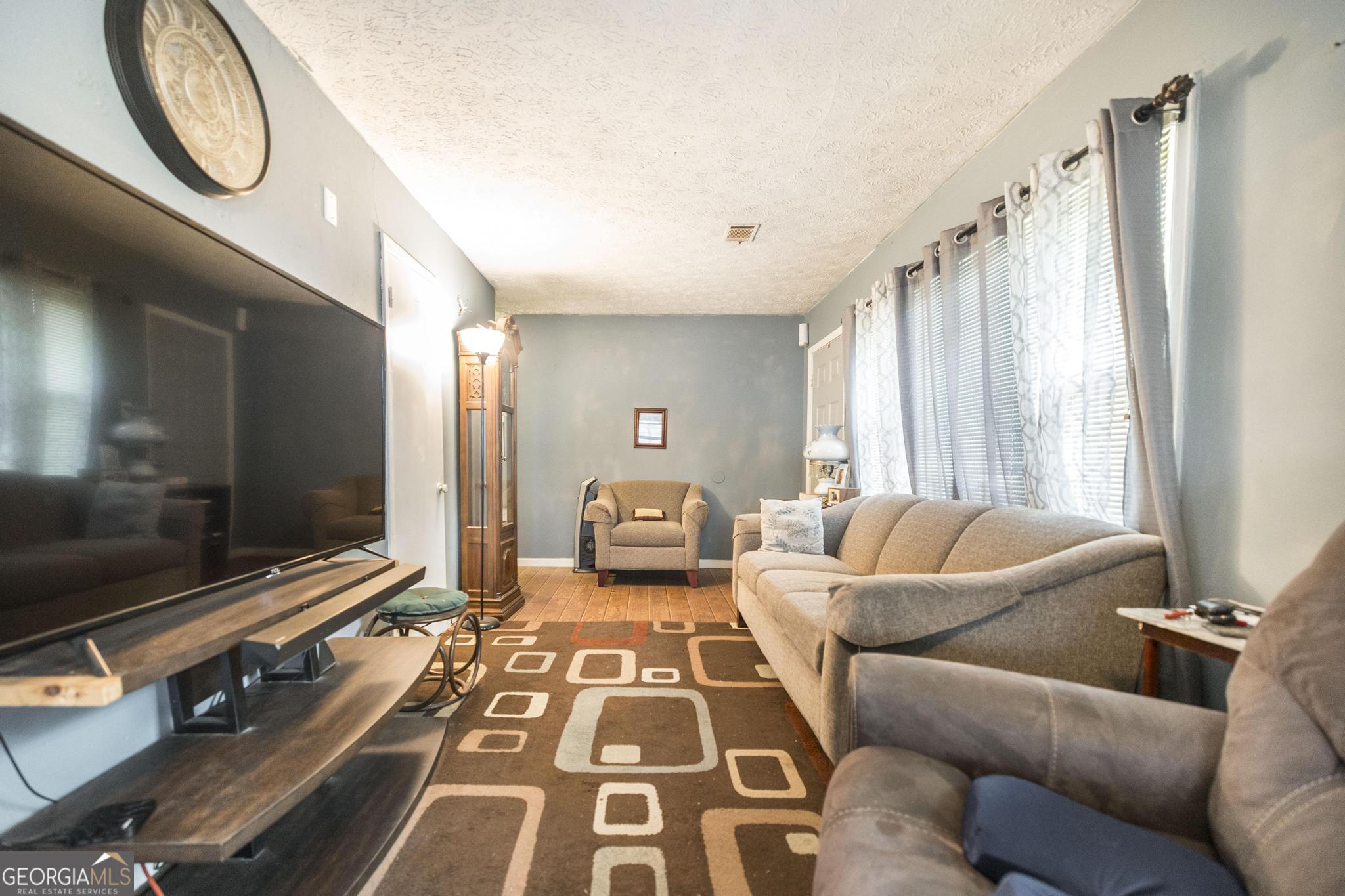 249 Ward Street Warner Robins, GA 31093 - Photo 9 of 22 a living room with furniture and a flat screen tv