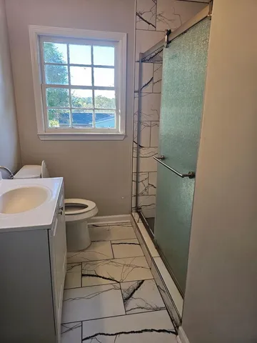 a bathroom with a sink toilet and shower