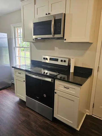 a kitchen with a stove and a microwave