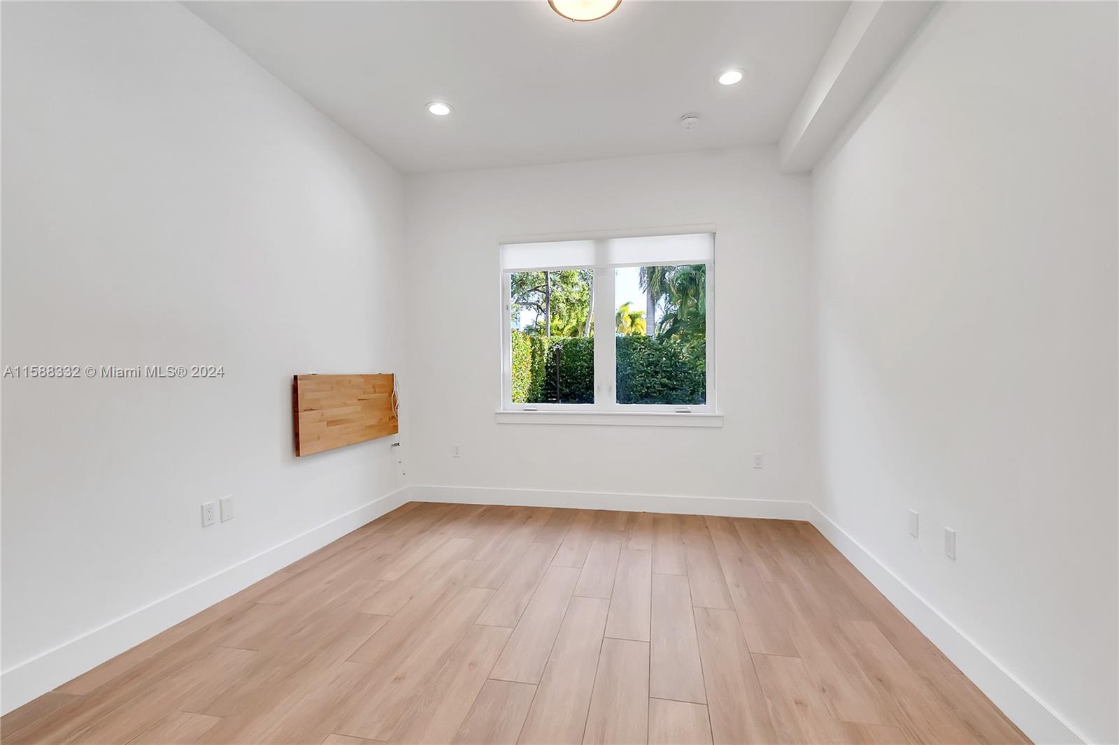 429 Southwest 23rd Road Miami, FL 33129 - Photo 25 of 46 an empty room with wooden floor and windows
