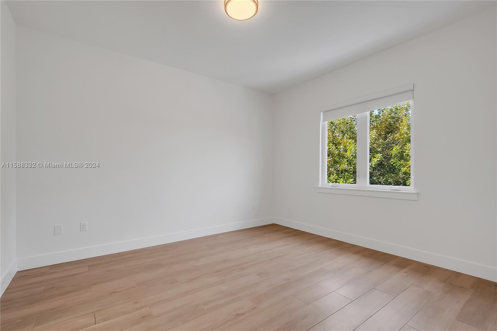 429 Southwest 23rd Road Miami, FL 33129 - Photo 32 of 46 an empty room with wooden floor and windows