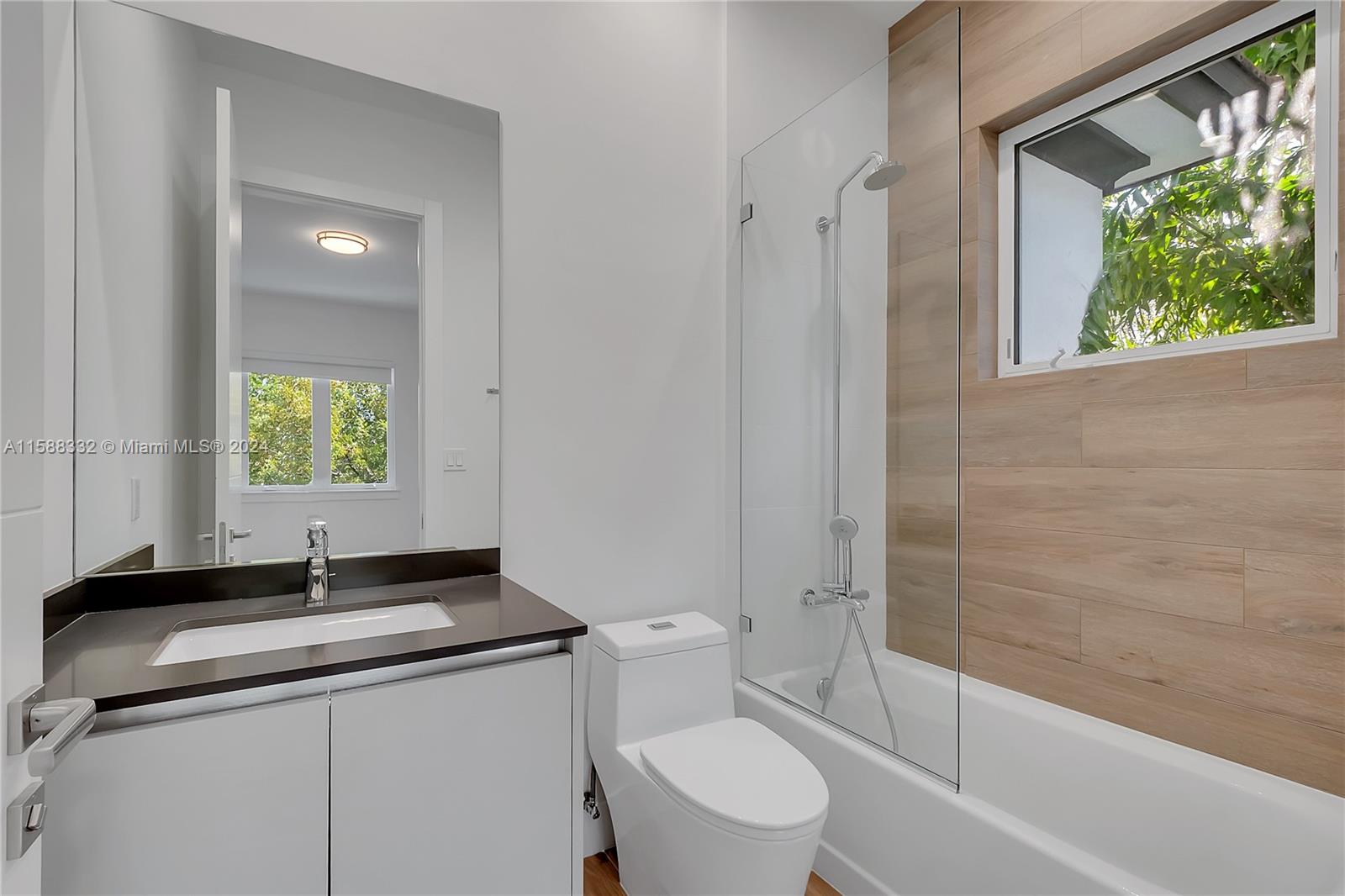 429 Southwest 23rd Road Miami, FL 33129 - Photo 33 of 46 a bathroom with a granite countertop sink toilet and shower