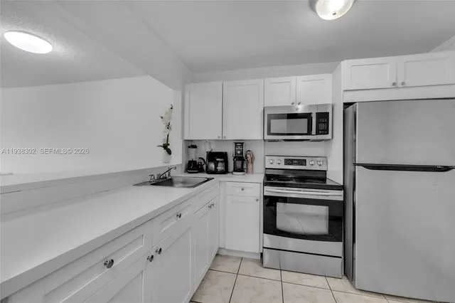 a kitchen with a sink and stainless steel appliances