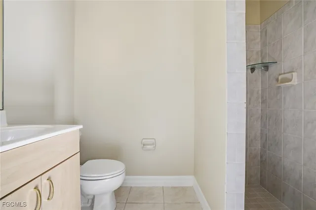 a bathroom with a sink a toilet and a shower