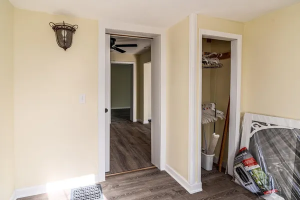 a view of a bedroom with hallway and closet