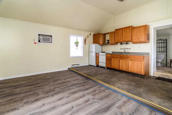 a kitchen with stainless steel appliances granite countertop a stove a sink and a refrigerator