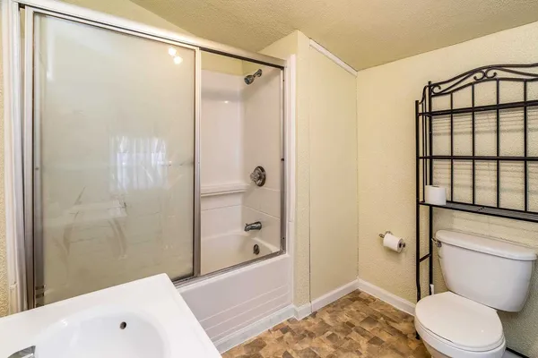 a bathroom with a sink toilet and shower