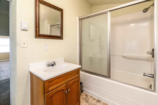 a bathroom with a sink a mirror and a shower