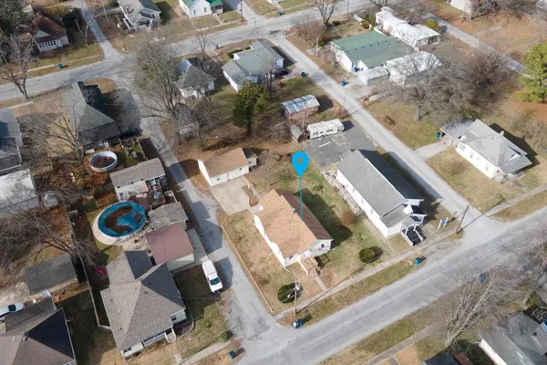 an aerial view of a house a patio swimming pool and outdoor seating