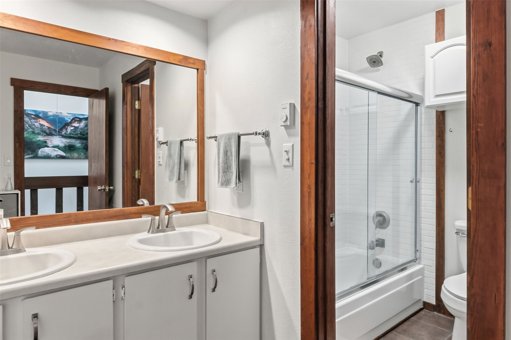 6920 Ryan Gulch Road, Unit 6920 Silverthorne, CO 80498 - Photo 28 of 48 a bathroom with a double vanity sink and mirror with bathtub