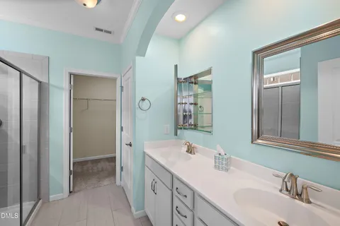 a bathroom with a granite countertop sink a toilet and shower