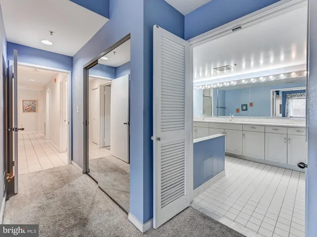 a spacious bedroom with a bed and a flat screen tv