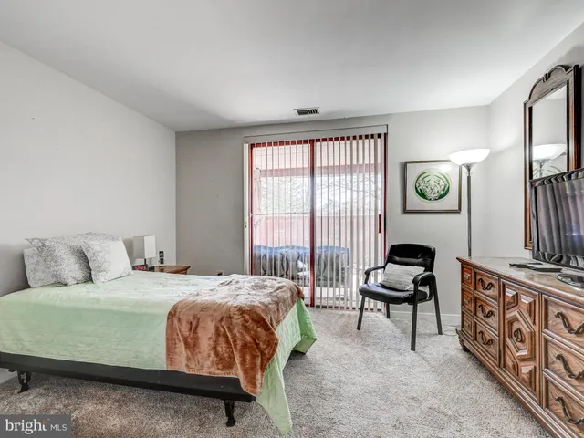 a spacious bathroom with a tub sink and mirror