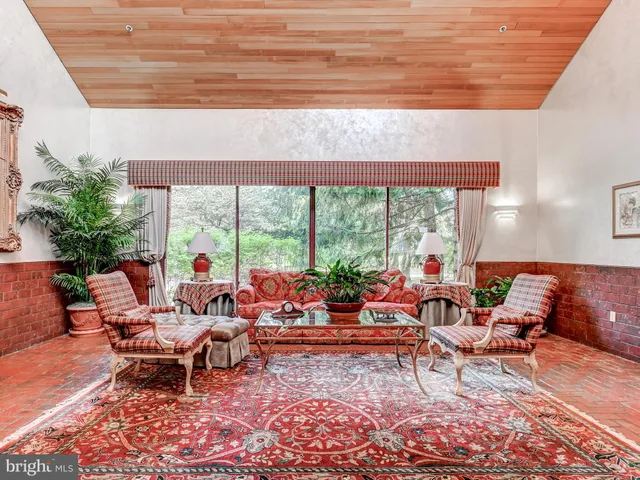 a living room with furniture and large windows