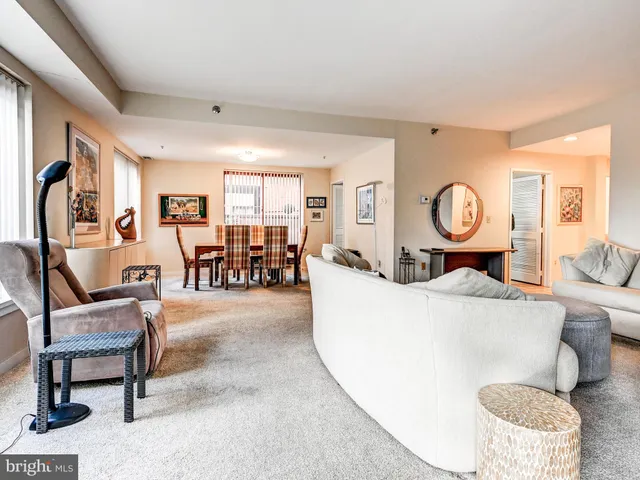 a front view of a house with garden and flowers