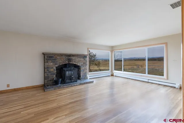 wooden floor fireplace and natural light in room