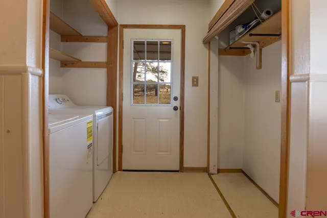 a view of a hallway with wooden floor and entryway
