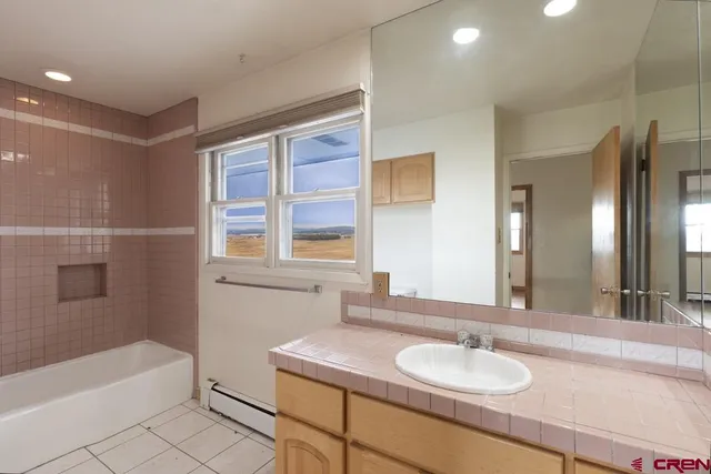 a view of an empty room with wooden floor and closet