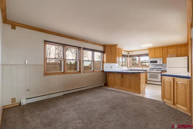 a room with kitchen island and a window