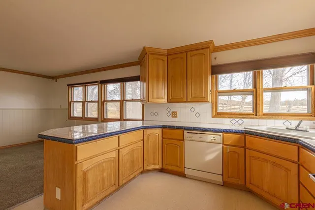 a kitchen with granite countertop sink and window