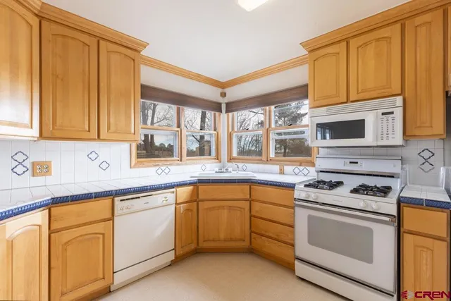 a kitchen with stainless steel appliances granite countertop a stove sink and cabinets