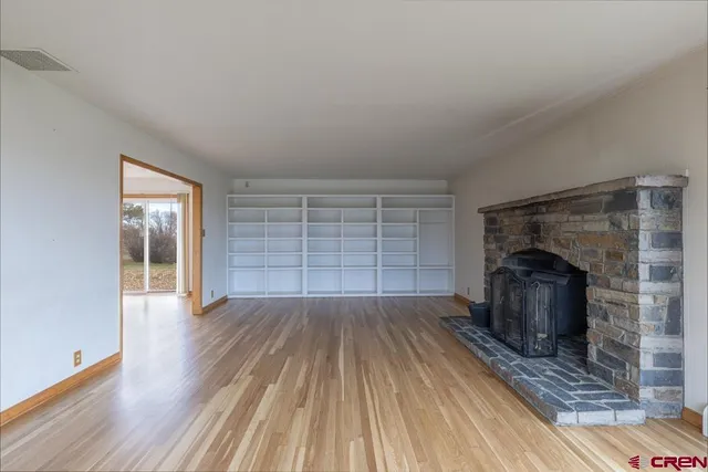 wooden floor in an empty room with a fireplace