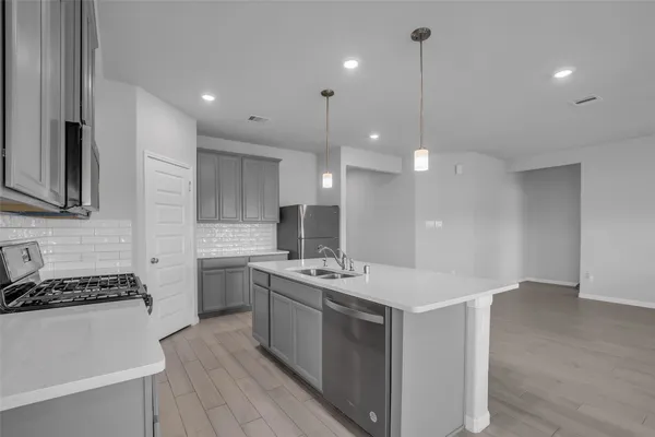 a kitchen with a sink stove and microwave
