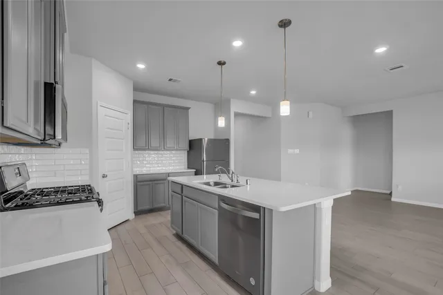 a kitchen with a sink stove and microwave