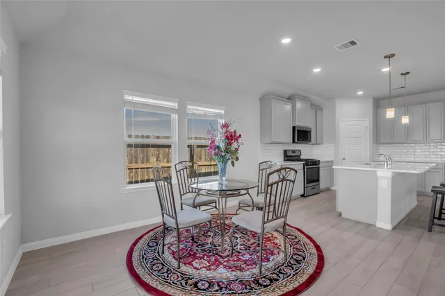 a view of a dining room with furniture and chandelier