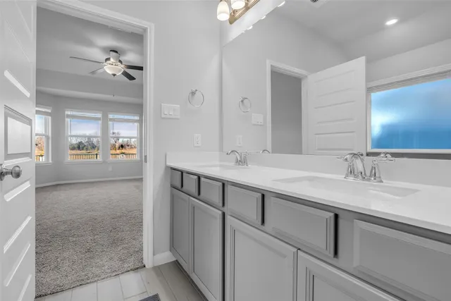 a en suite bathroom with double sink and a mirror
