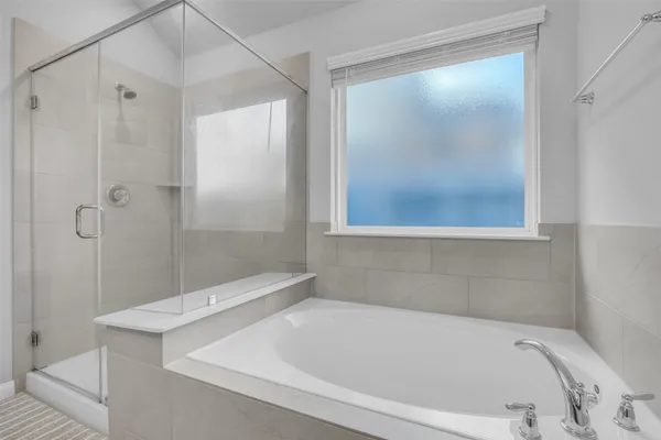 a bathroom with a tub and shower