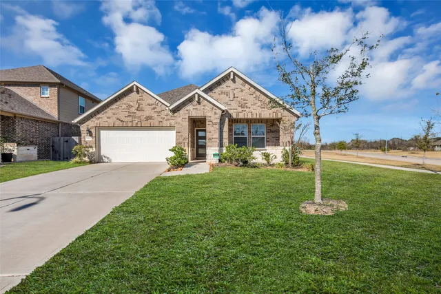 a view of a house with a yard and a garden