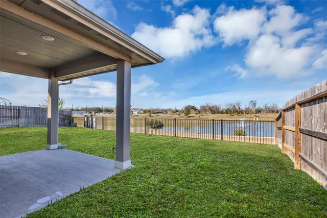 a view of a house with a yard and a porch