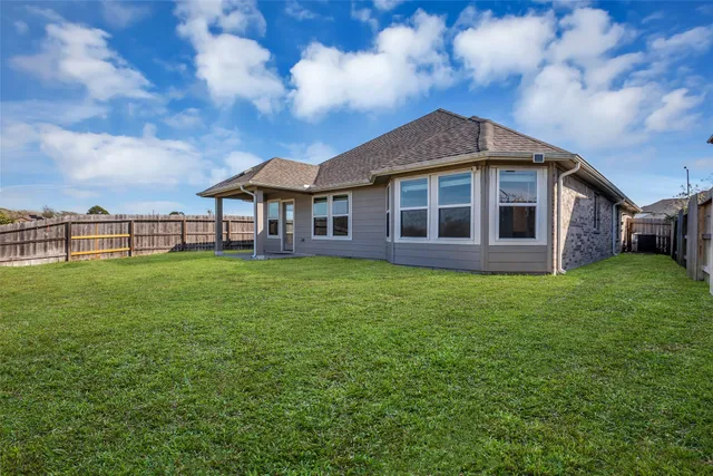 a view of a house with a yard and sitting area