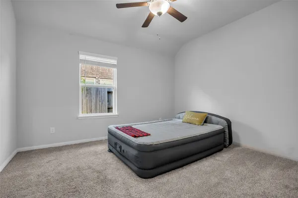 a bedroom with a bed and window
