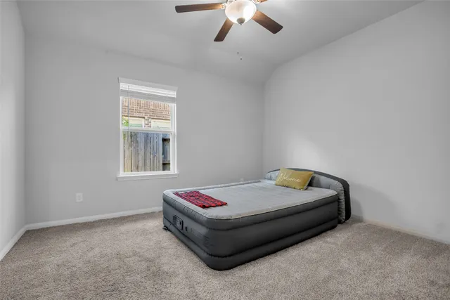 a bedroom with a bed and window