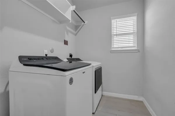 a utility room with closet and window