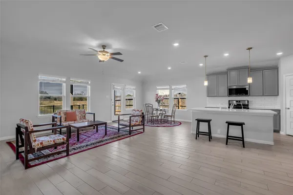 a living room with furniture and kitchen view