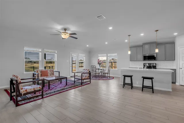 a living room with furniture and kitchen view