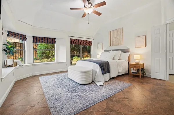 a spacious bedroom with a bed and window