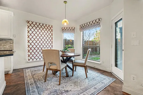 a dining room with furniture a rug and wooden floor